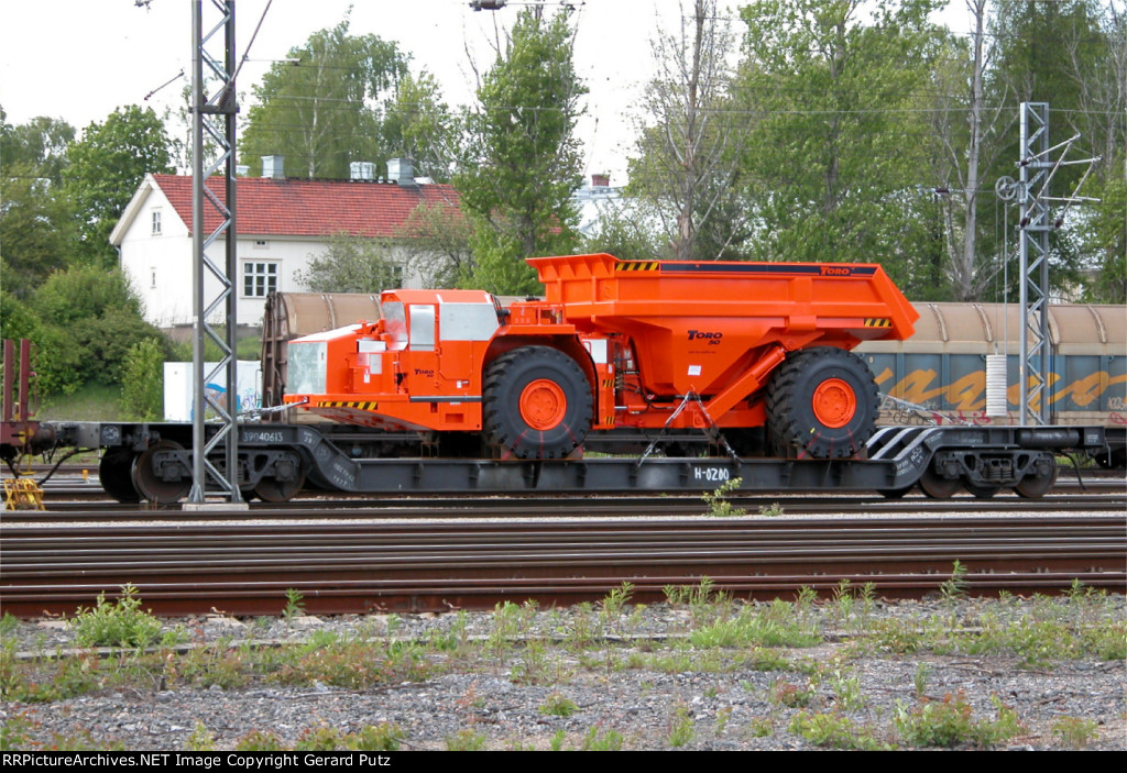 Mining dump truck on Russian depressed-center flat car